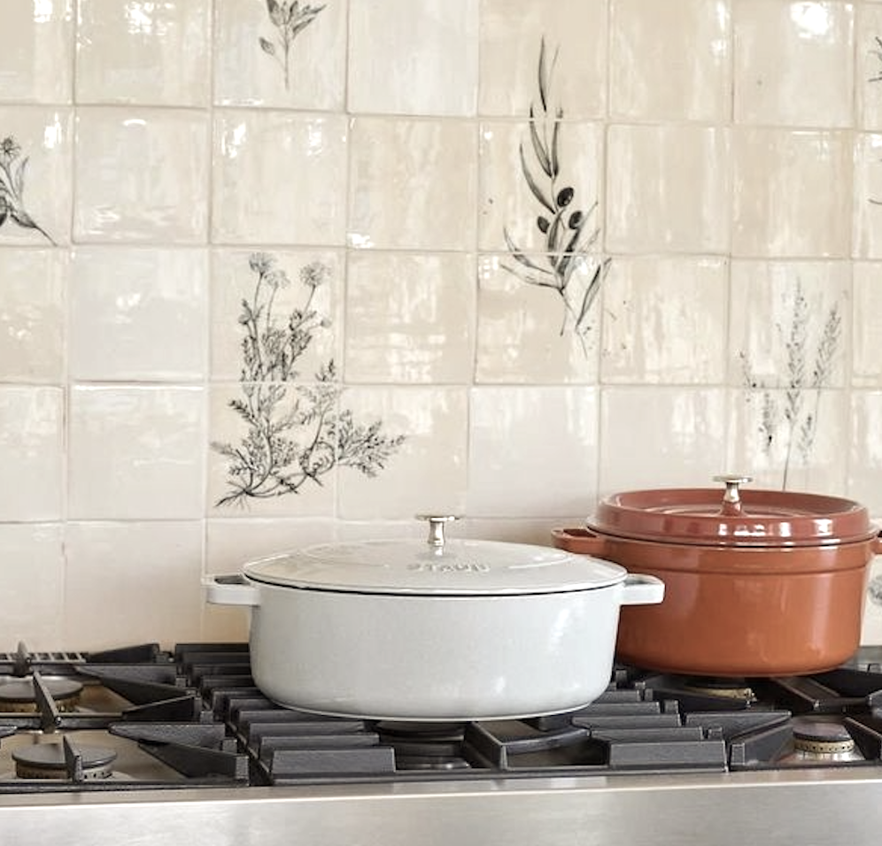 Cream tiled kitchen wall and pale enamel pot
